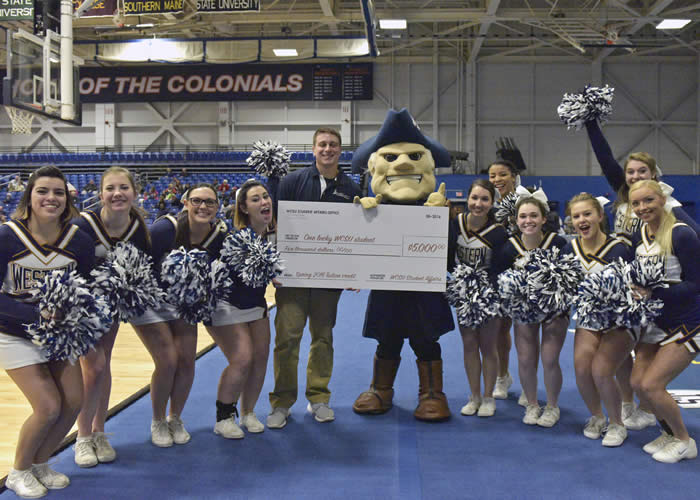 Image William Alfiere with Colonial Chuck and WCSU cheerleaders following his successful half-court shot.