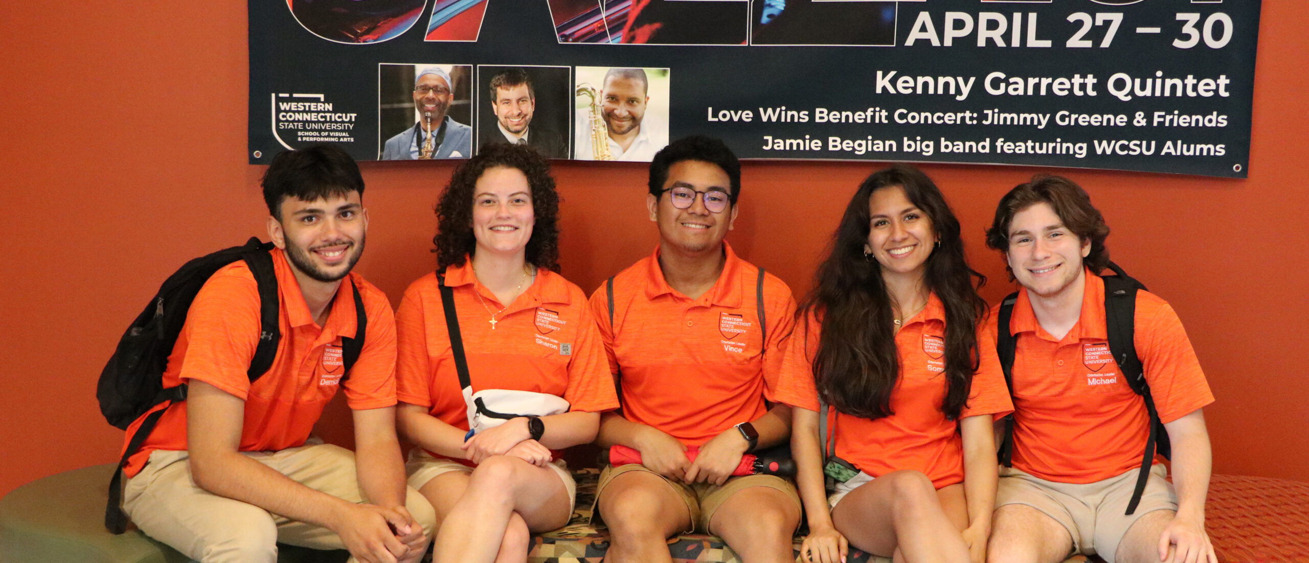 5 student orientation leaders sitting on a bench together