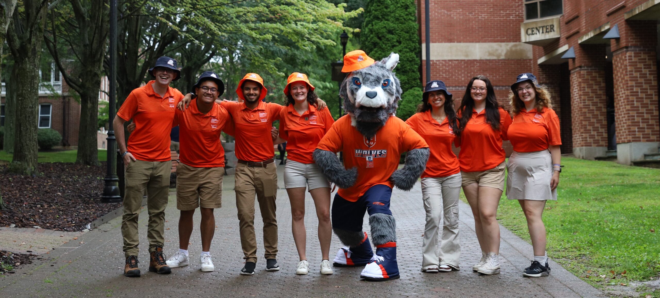 student leaders standing outside with wolf mascot