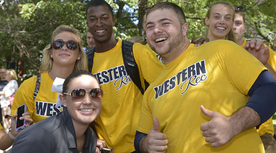 Several students of diversity posing with smiles and wearing yellow t-shirts that say Western Rec.