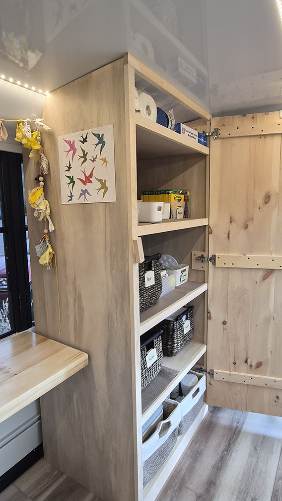 Close‑up of art supplies and tools arranged inside the Artlighten Mobile Art Therapy Studio.