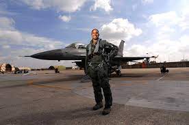 Women Pilot standing in front of a fighter jet.