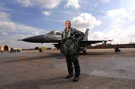Women Pilot standing in front of a fighter jet.