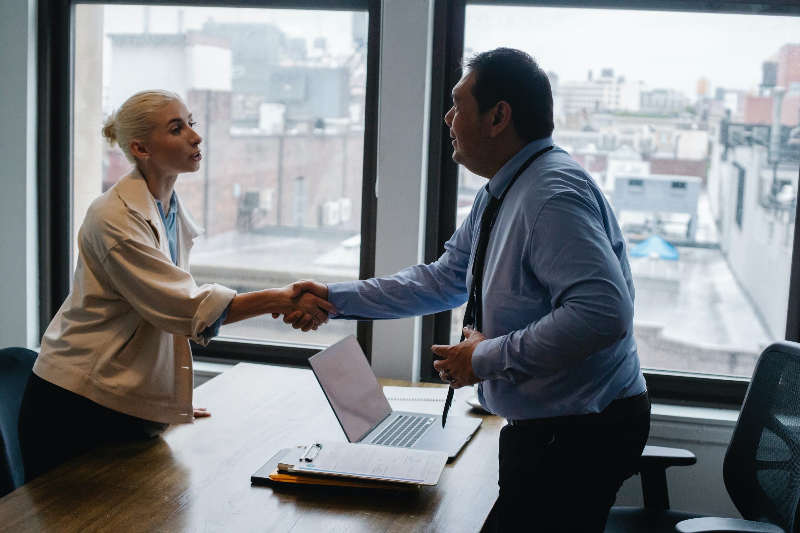 Two people in business attire shaking hands