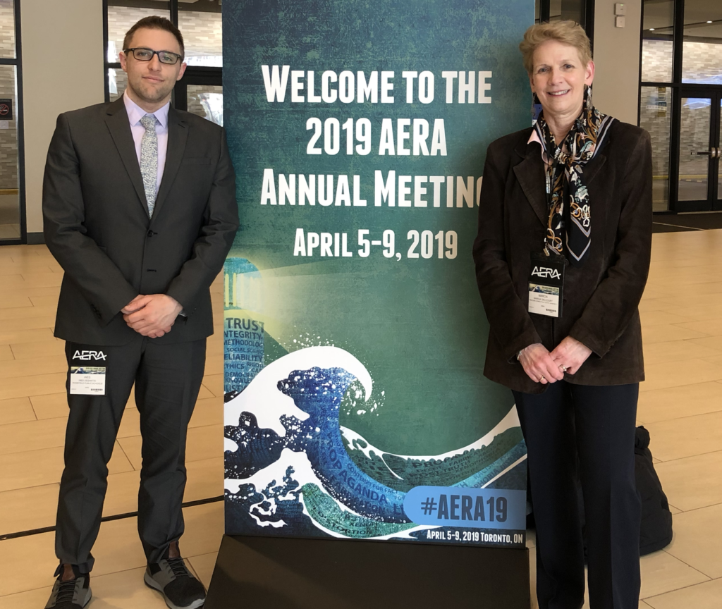 Dr. DeSantis and Dr. Delcourt standing next the the Welcome to the 2019 Area Annual Meeting sign