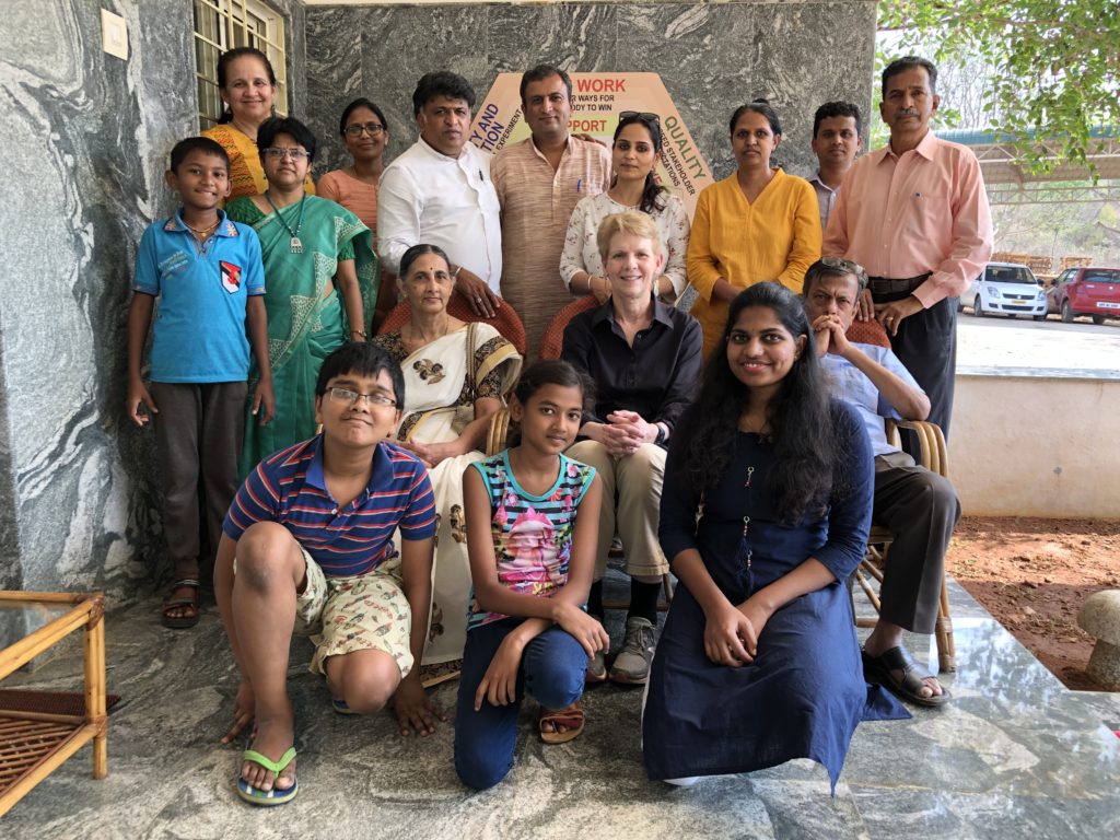 Dr. Marcia Delcourt sitting in with a group of people from India