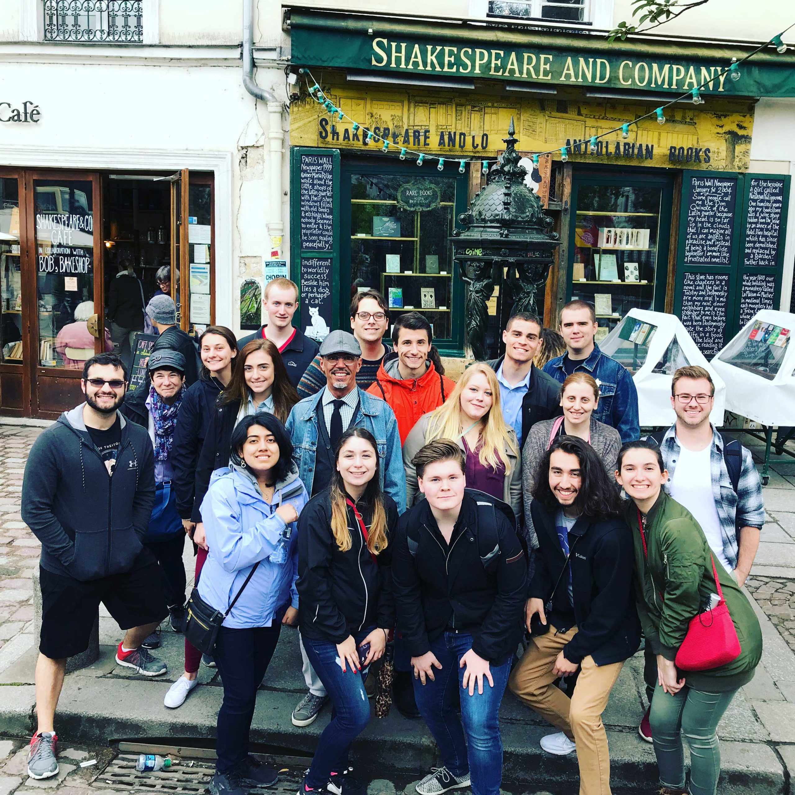 Students and professors take a group photo outside of Shakespeare and Company, a local bookstore in Paris.