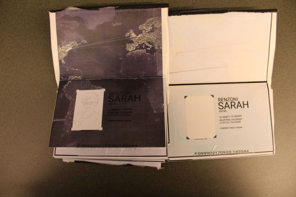 An unfolded passport sits on the left. Its background is a picture of the Atlantic Ocean and its surrounding continents. There are lights where there are major cities and flights. A few lines stretch out from New York to Europe, Africa, and South America. The passport is for Sarah Renzoni, and a drawing represents their ID photo. A prototype of this passport sits to its right.