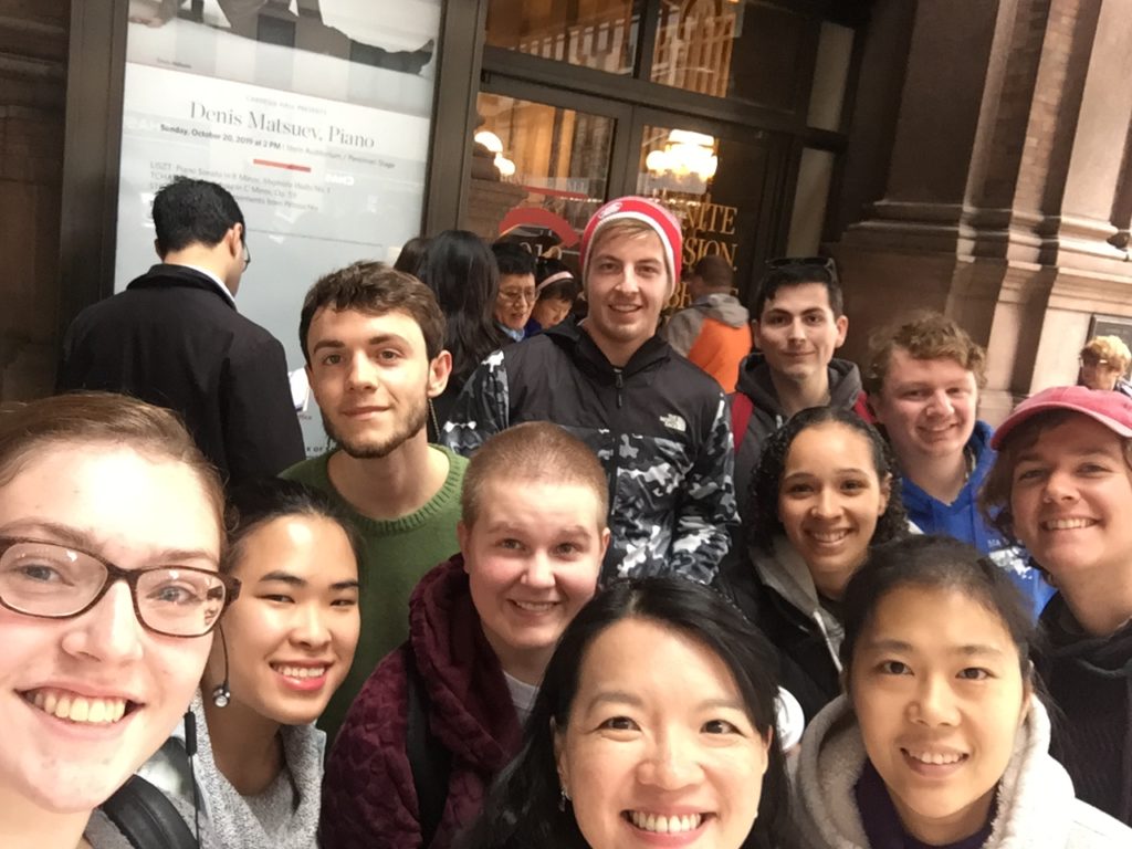Piano students with Dr. Chang taking a selfie in front of Carnegie Hall