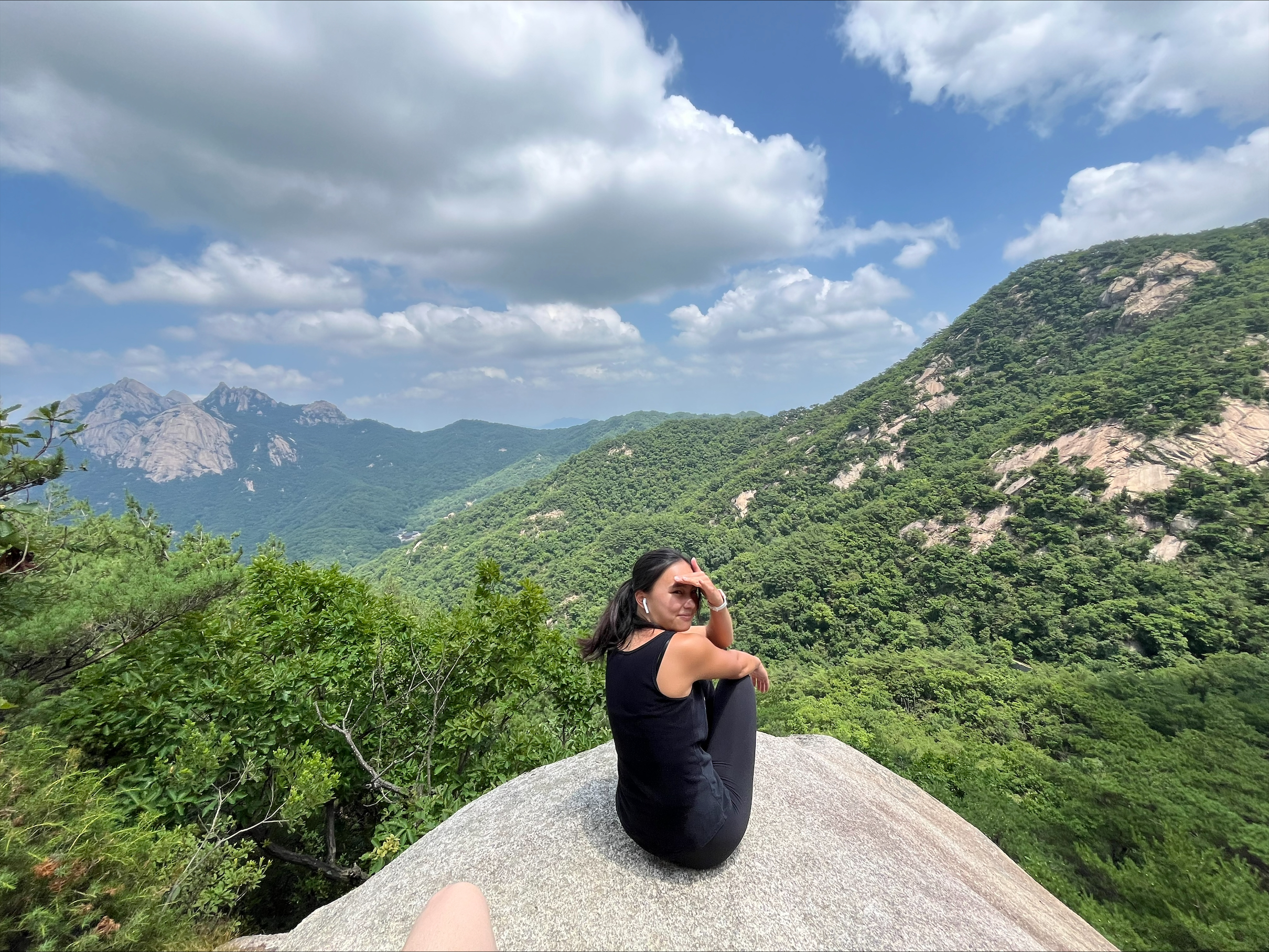 Student Maia Quirk sitting at a forest overlook in South Korea.