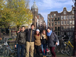 WCSU students, studying abroad in Amsterdam, pose together in front of some Amsterdam architecture.