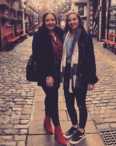 Brianna and Catherine standing in the middle of a quaint cobblestone street