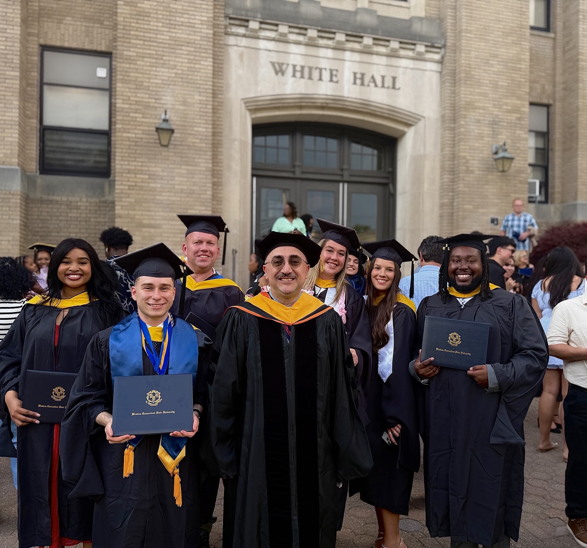 Students Michael Azzi, Eric Scorca, Dominique Gagne, Briana Beekman, Keanu Morgan, and Elihle Sangweni, with the graduate program coordinator/JLA chair, Dr. Arslan, during the 2026 commencement