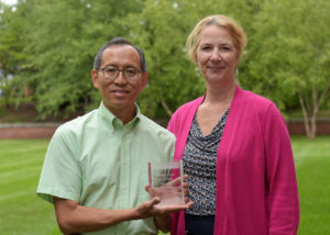image of Associate Professor of Biological and Environmental Sciences Dr. Edwin Wong receives the Provost's Teaching Award from Dr. Missy Alexander