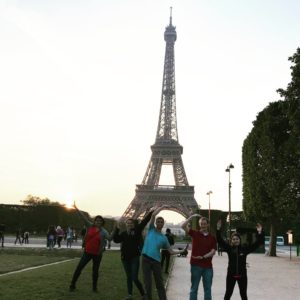 Image of students as they spell out "WCSU" in front of the Eiffel Tower