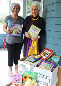 image of Professor Emeritus of Social Work Dr. Patti Ivry and Professor Emeritus of Education Dr. Darla Shaw with some of the books Shaw donated to Impact Network.