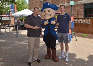 image of Doug and Brandon Muckerman pose with Colonial Chuck at Orientation.