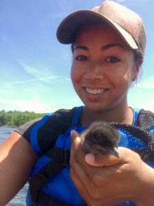 Ericka Griggs holding a young loon.