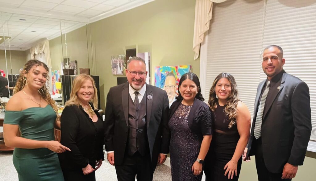 Alumni and Staff with Dr. Miguel Cardona