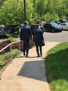 Professor of Justice & Law Administration Terry Dwyer walks with Raneil Smith after his UConn Law School commencement.