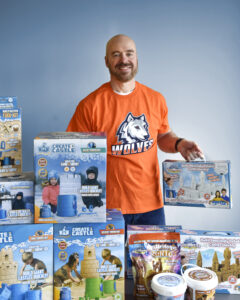 WCSU alumnus Kevin Lane, founder of Create a Castle and “Shark Tank” winner, shows off his WCSU Wolves pride while displaying some of his products.