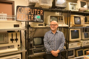 MIS Professor Dr. Emilio Collar with his IBM 5120 and other vintage computers in his collection.