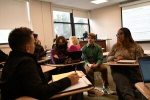 Dr. H. Howell Williams (left) and Chris Powers (center) during a class discussion in "The Politics of the 1990s."