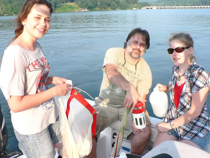 Image of Professor Mitch Wagener with former students Bruna Oliviera and Catrina Morgan