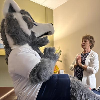 Wally the wolf meditates with a woman