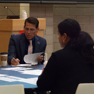 President Bernal and Melissa Stephens at work in professional attire