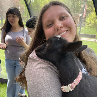 Student holding a lamb