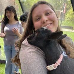 Student holding a lamb