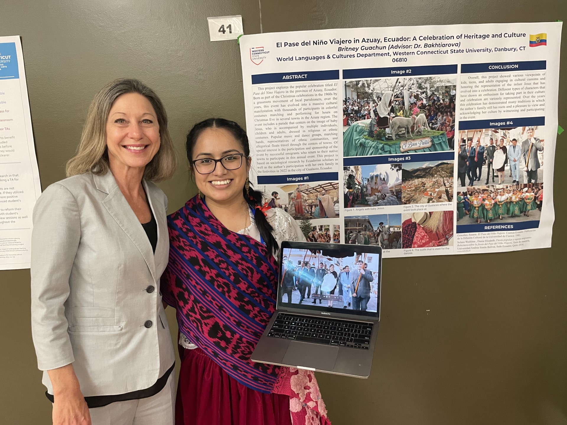 Dr. Stacey Alba Hawkins with a student and her presentation.